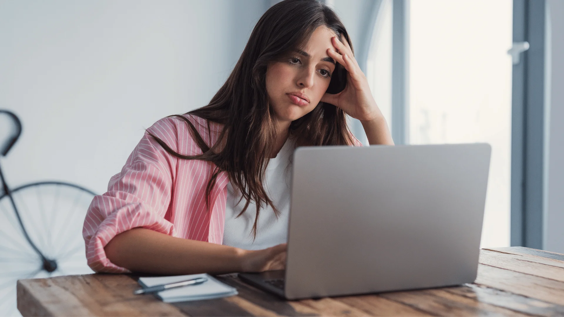 woman frustrated staring at laptop as she thinks everything feels kinda pointless lately