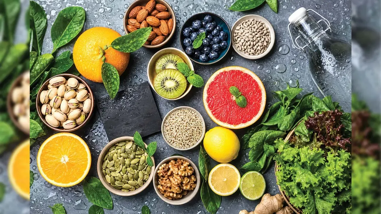 Flat lay of vibrant citrus fruits, mixed nuts, seeds, fresh blueberries, and green leafy vegetables for nutrition.
