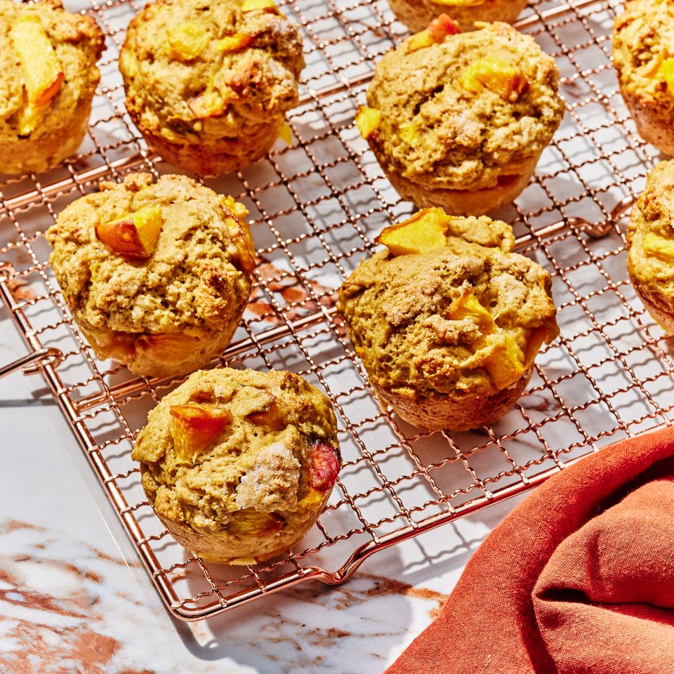 a recipe photo of the High-Protein Peach Muffins Credit: Photographer: Morgan Hunt Glaze, Prop Stylist: Priscilla Montiel, Food Stylist: Julian Hensarling