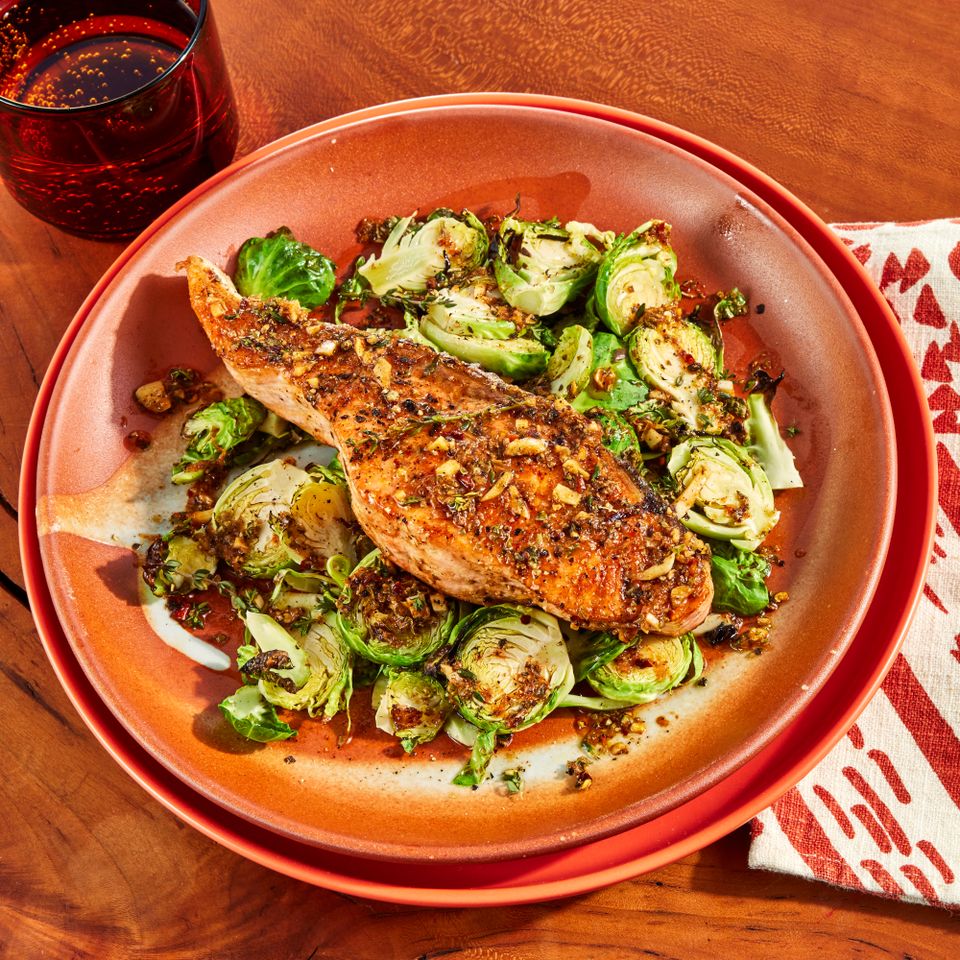 an image of the Sheet-Pan Salmon & Shaved Brussels with Lemon-Garlic Drizzle Credit: Photographer: Jen Causey, Food Stylist: Margaret Monroe Dickey, Prop Stylist: Priscilla Montiel