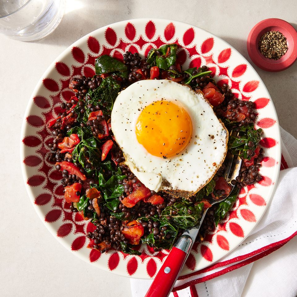 Overhead view of a plate of Braised Lentils & Kale with Fried Eggs recipe Credit: Photographer: Jen Causey, Food Stylist: Melissa Gray, Prop Stylist: Shell Royster