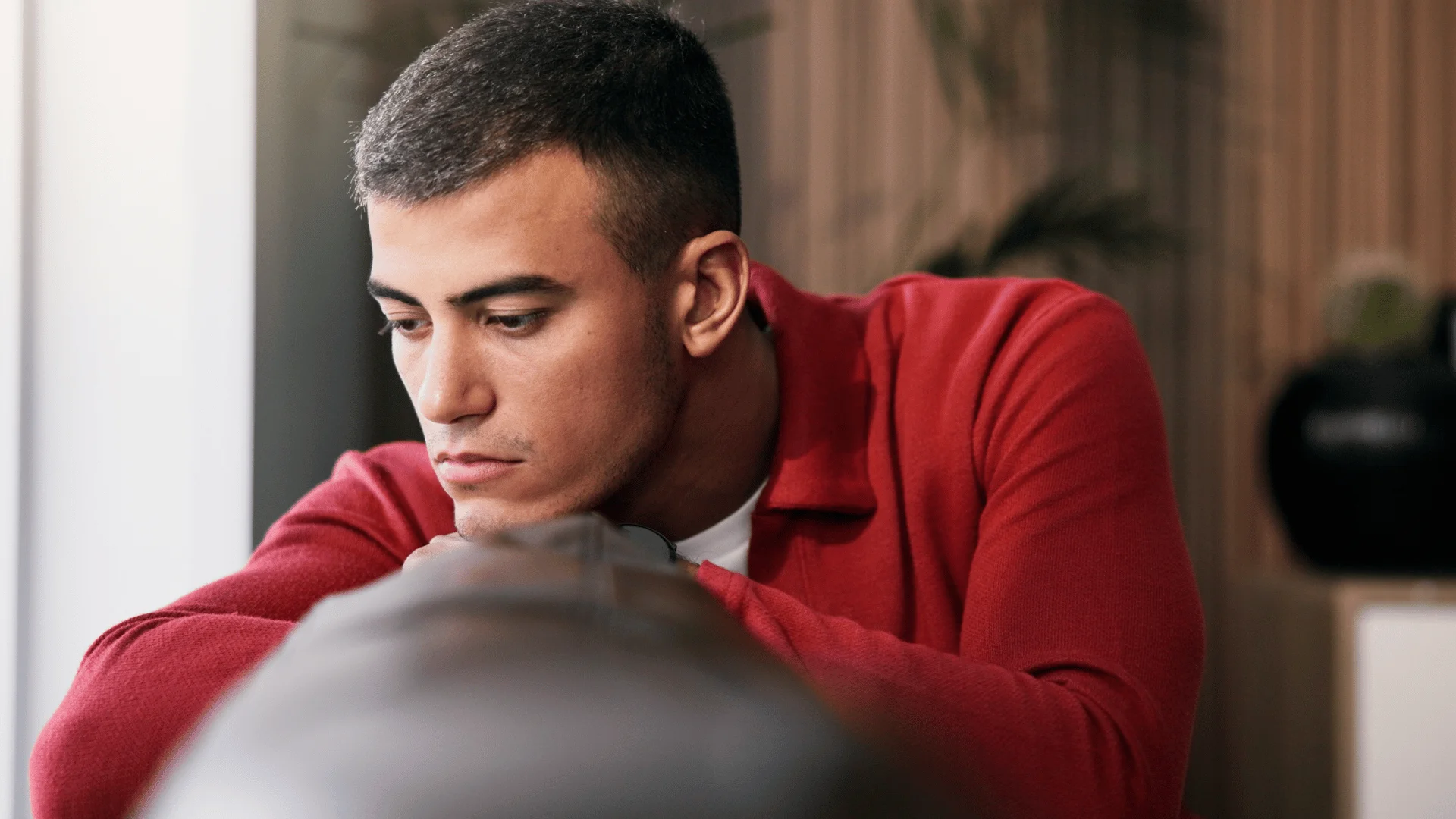 man in red shirt on the couch as he thinks i haven't been myself lately