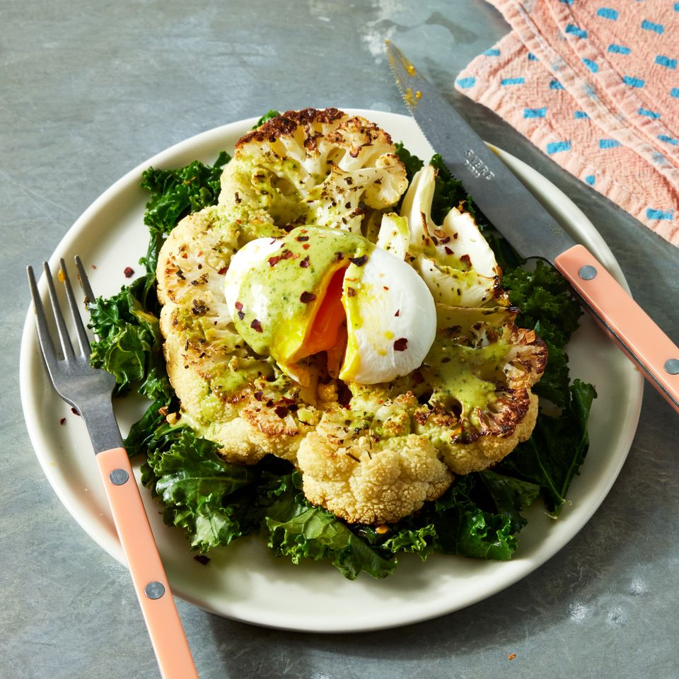 a recipe photo of the Cauliflower Steaks with Poached Eggs & Pesto Hollandaise Credit: Photographer: Jen Causey, Food Stylist: Jennifer Wendorf, Prop Stylist: Priscilla Montiel