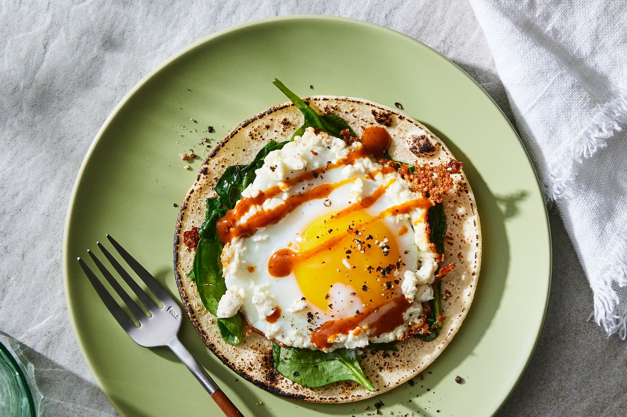 a recipe photo of the Feta, Egg & Spinach Breakfast Taco Credit: Photographer: Rachel Marek, Food stylist: Holly Dreesman, Prop stylist: Gabriel Greco