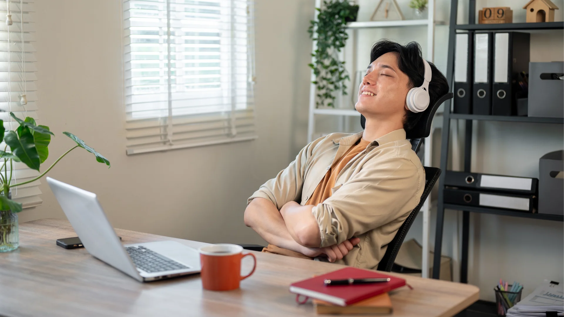 man who needs naps and quiet time to function resting his eyes at his desk at work