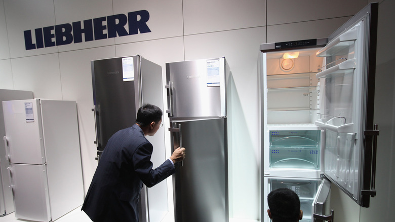 Visitors opening and viewing Liebherr refrigerators at an IFA trade show display