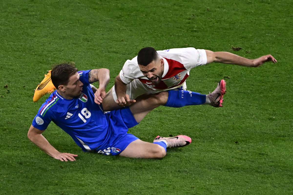Italy's midfielder #18 Nicolo Barella and Croatia's midfielder #08 Mateo Kovacic collide during the UEFA Euro 2024 Group B football match between Croatia and Italy at the Leipzig Stadium in Leipzig on June 24, 2024. (Photo by JOHN MACDOUGALL / AFP) (Photo by JOHN MACDOUGALL/AFP via Getty Images)