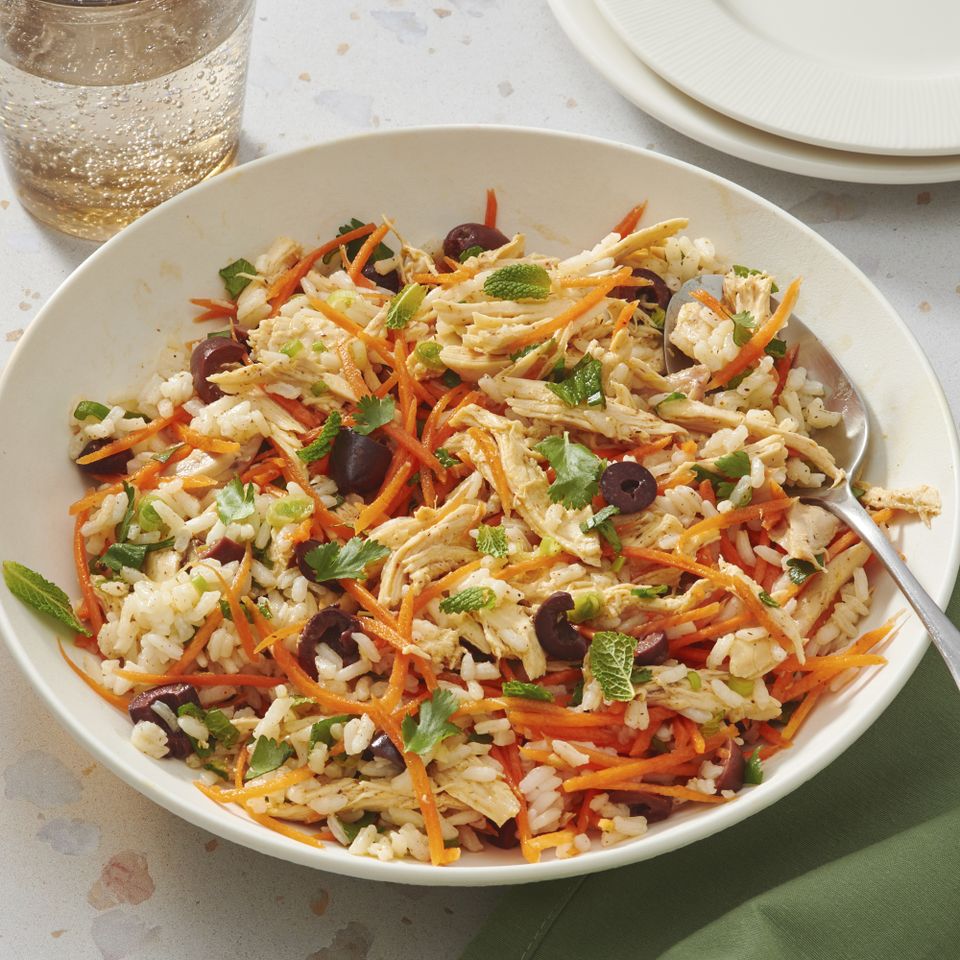 Bowl of herbed chicken salad with shredded chicken carrots rice and herbs Credit: Diana Chistruga