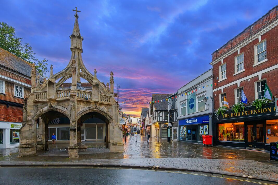 The 14th century Poultry Cross market cross with illuminated Butcher Row street behind, in Salisbury, Wiltshire, England. The 14th century Poultry Cross market cross with illuminated Butcher Row street behind, in Salisbury, Wiltshire, England.