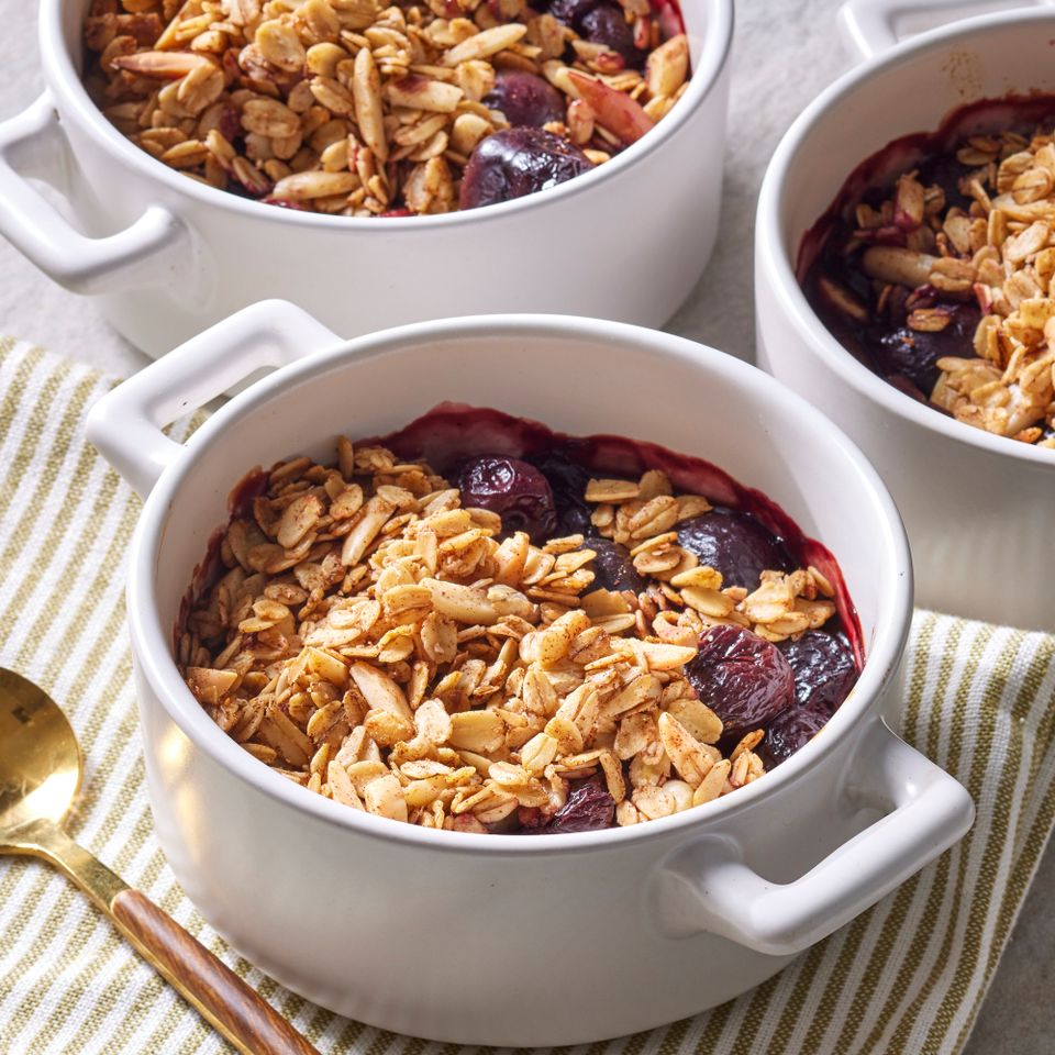 an image of the Cherry Crumble served in small baking dishes Credit: Photographer: Grant Webster, Food Stylist: Lauren McAnelly, Prop Stylist: Gabriel Greco