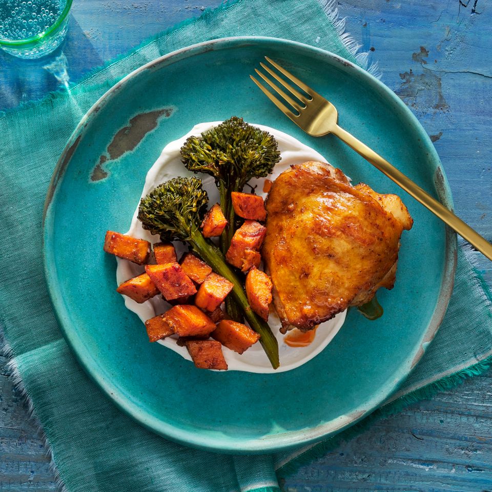 a recipe photo of the Chicken Thighs with Sweet Potatoes & Broccolini Credit: Photographer: Fred Hardy, Food Stylist: Jennifer Wendorf, Prop Stylist: Lydia Pursell