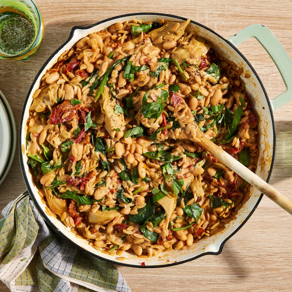 an image of the Creamy White Bean & Sun-Dried Tomato Orzo with Spinach & Artichokes Credit: Photographer: Jen Causey, Food Stylist: Margaret Monroe Dickey, Prop Stylist: Christina Daley