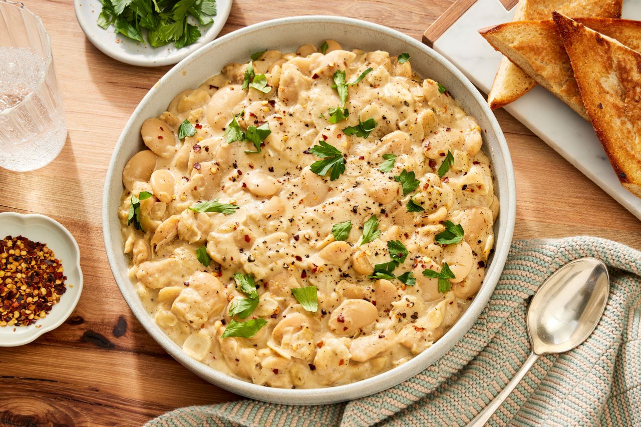 an image of the Creamy Garlic-Parmesan Butter Beans Credit: Photographer: Robby Lozano, Food Stylist: Craig Huff, Prop Stylist: Abby Armstrong