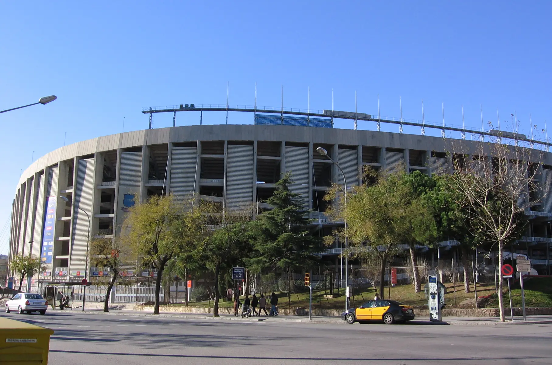 External view of the Camp Nou stadium in Barcelona under a clear blue sky.
