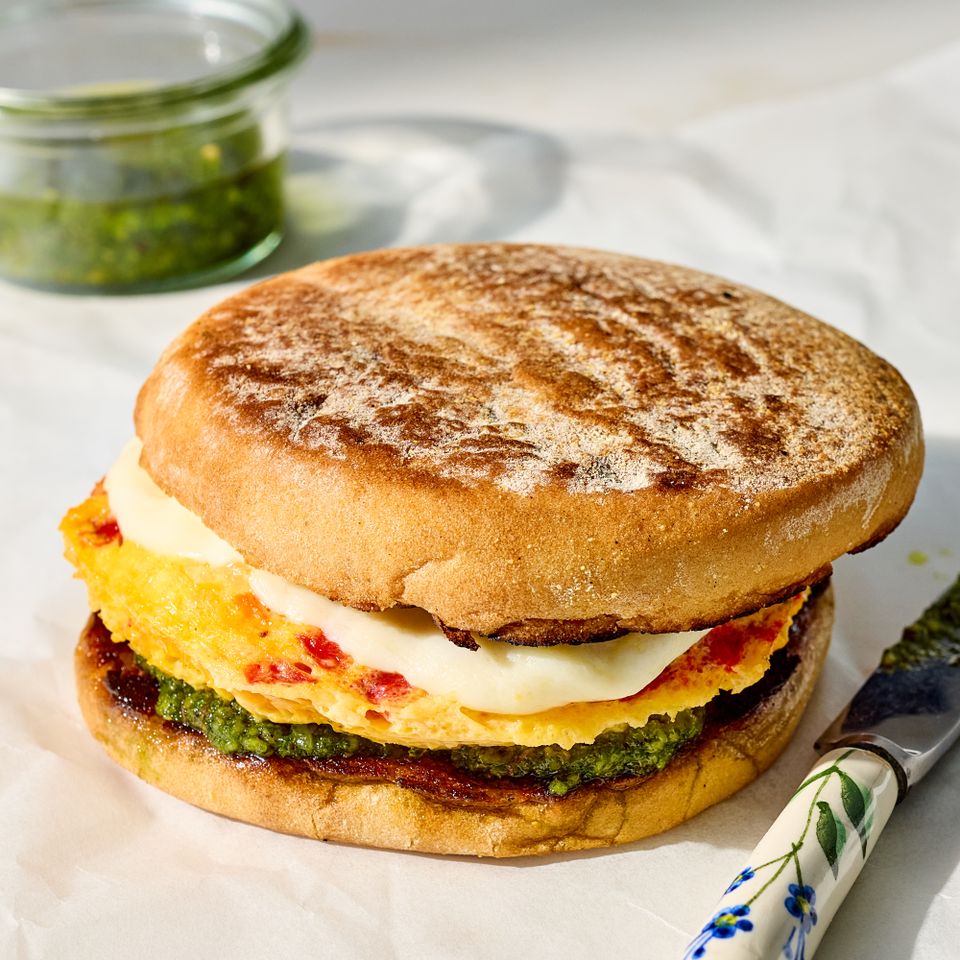 Breakfast sandwich with egg mozzarella pesto and a toasted English muffin knife on the side Credit: Photographer: Jake Sternquist, Food Stylist: Shannon Goforth, Prop Stylist: Natalie Ghazali