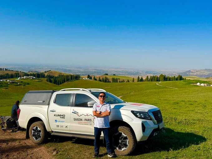 Mr. Hai took a photo next to the car driving from Vietnam to Europe in Xinjiang, China on July 20.