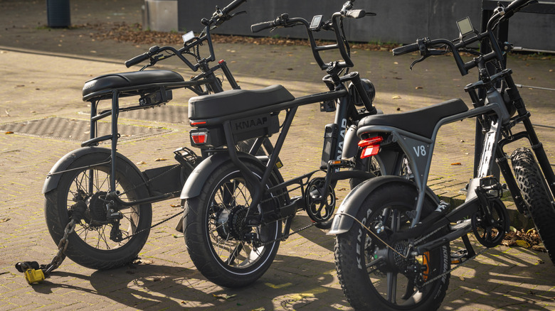 Three e-bikes on side of road
