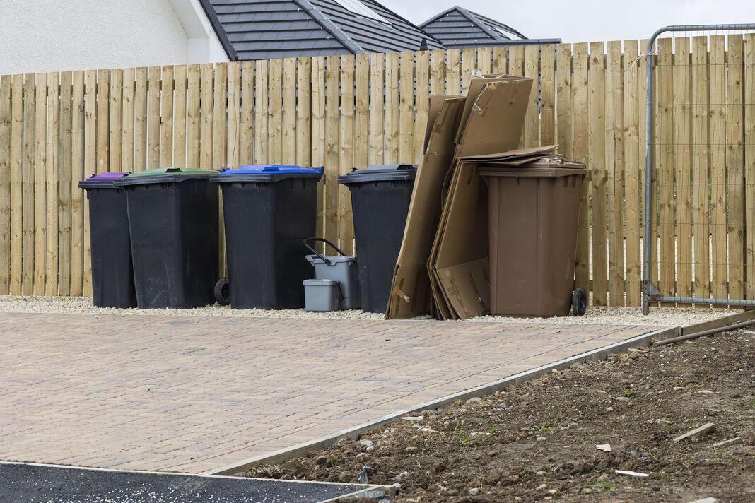 Household recycling and waste bins outside modern new build homes Household recycling and waste bins outside modern new build homes