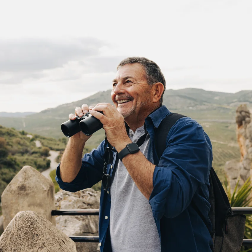 man over 60 happily looking at view focuses on the positives of life