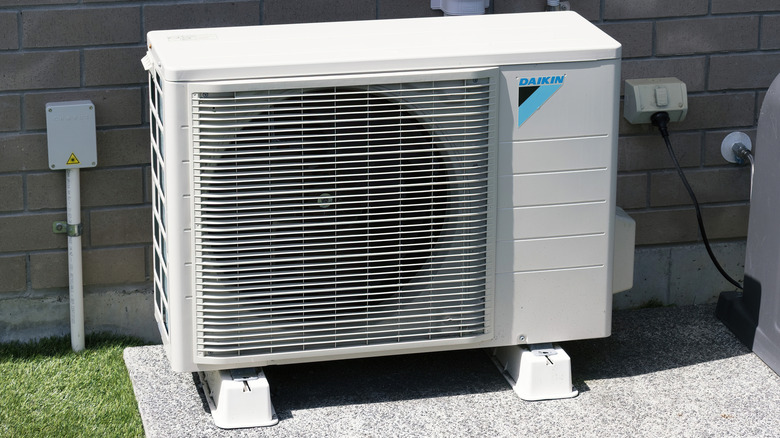 outdoor Daikin air conditioner unit against a brick wall