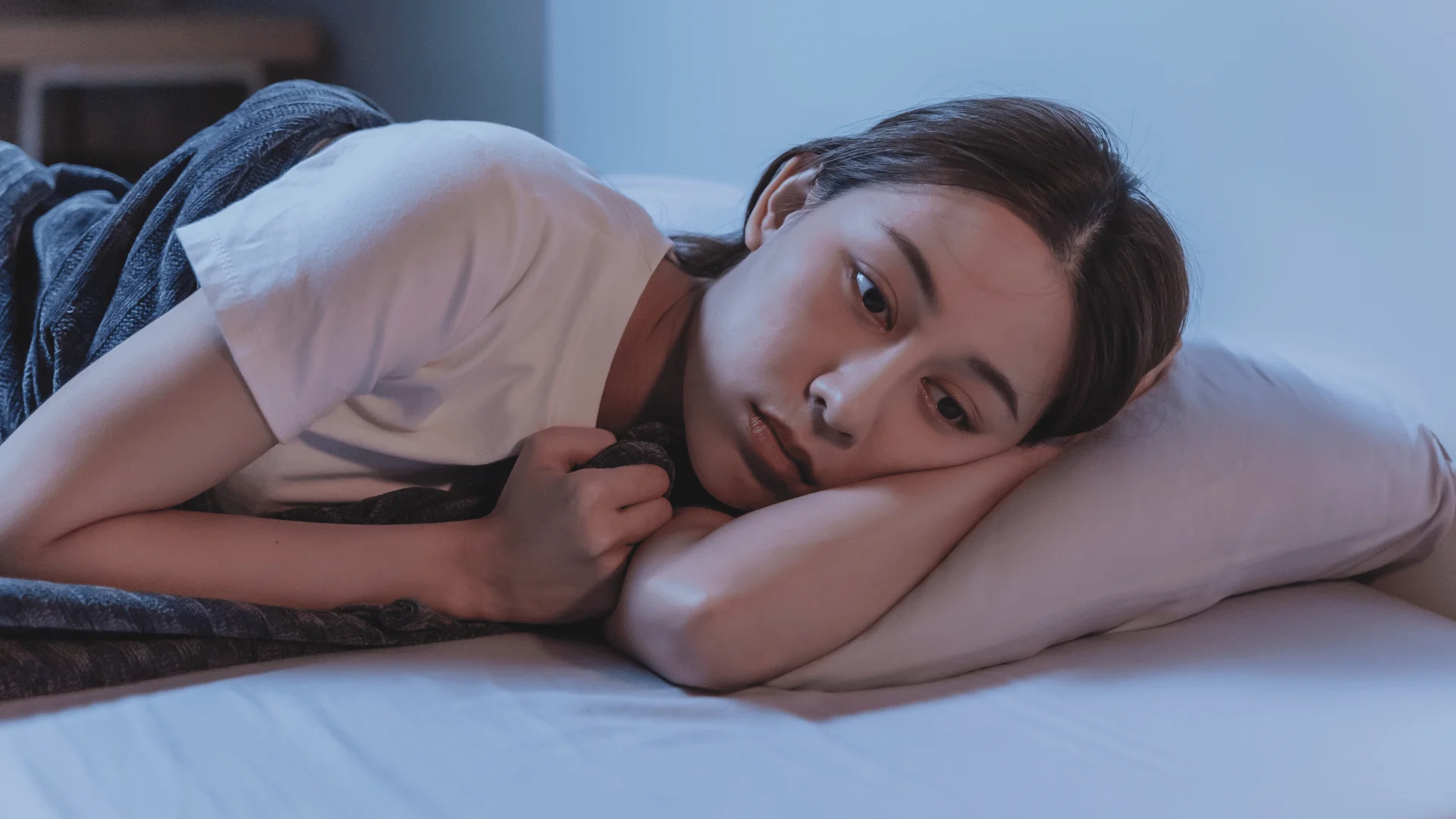 woman with insomnia in bed who can't sleep