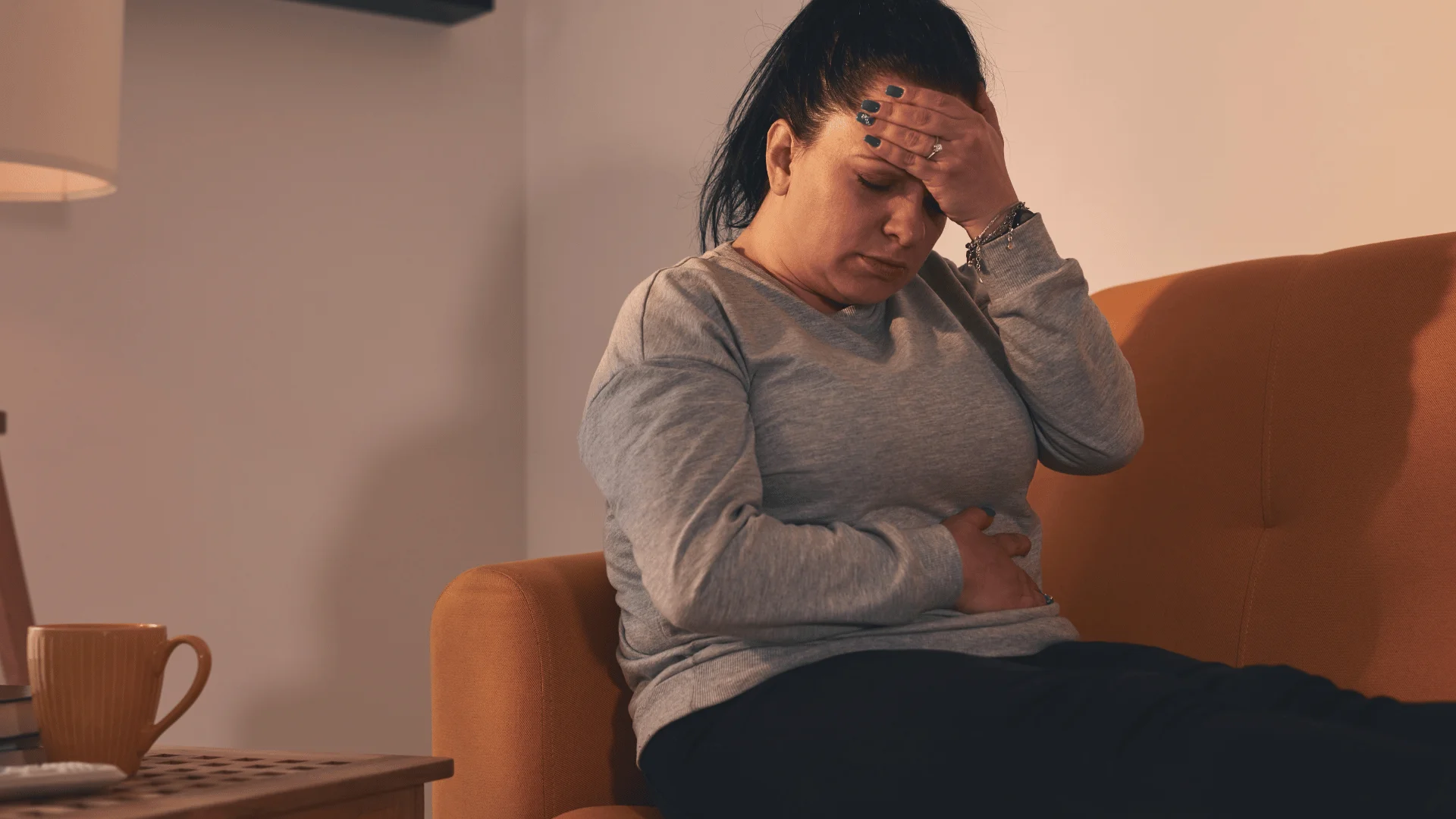 woman with stomach ache feeling pain