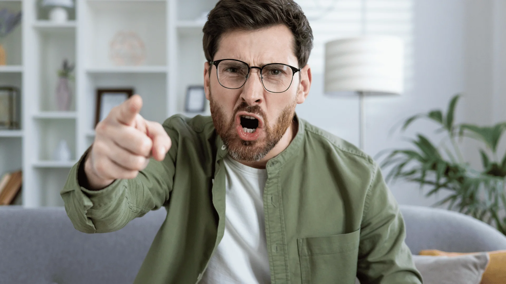 angry man yelling feeling exhausted sitting at home