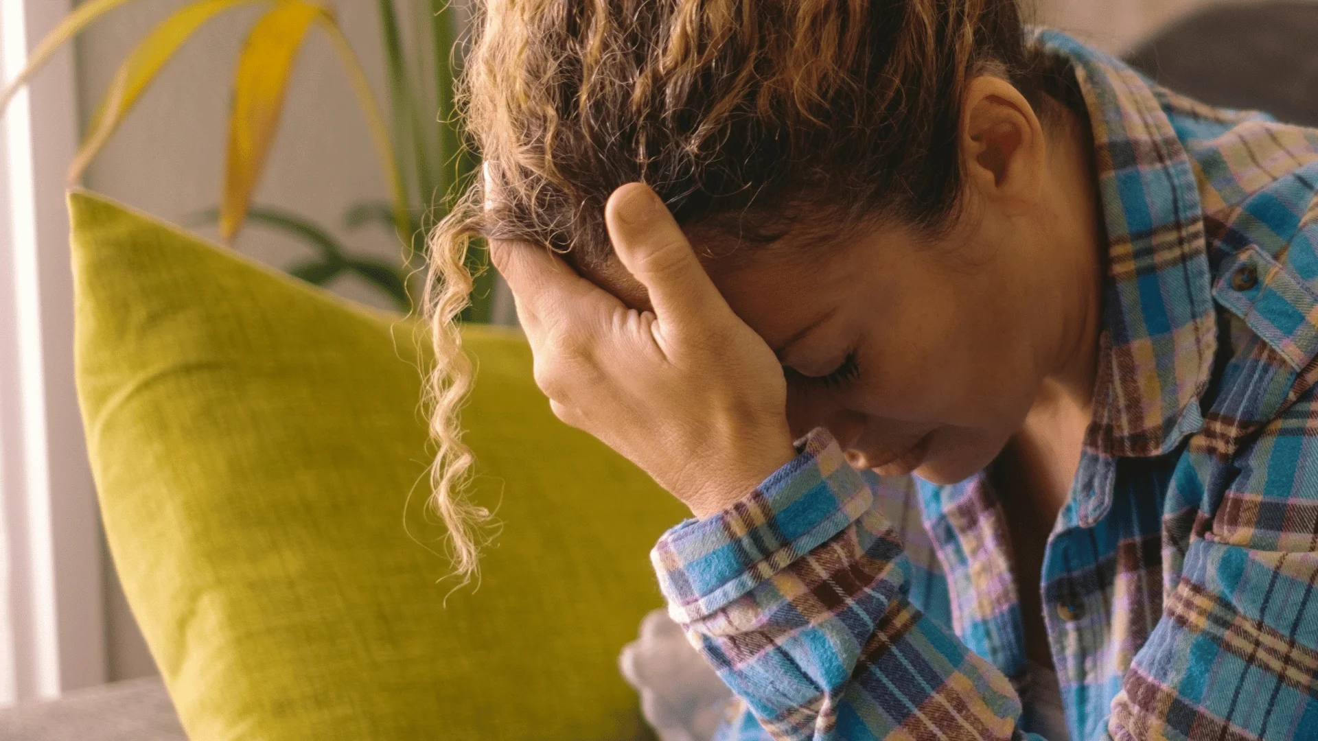 sad depressed woman with her head in her hands