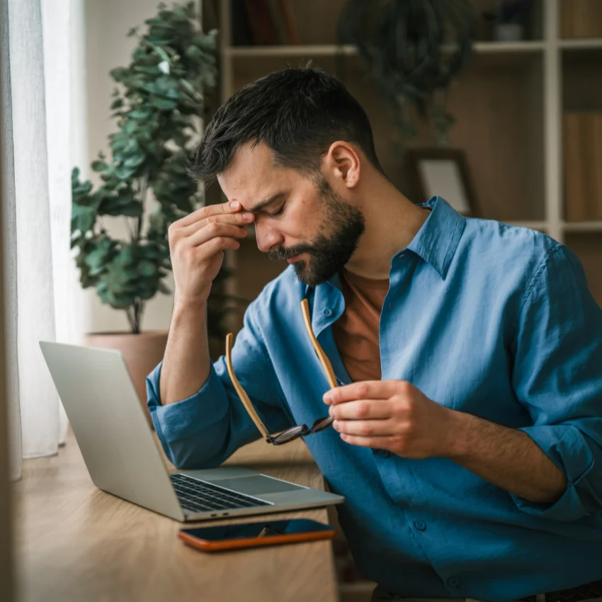 empath man feeling drained at his desk in his toxic workplace