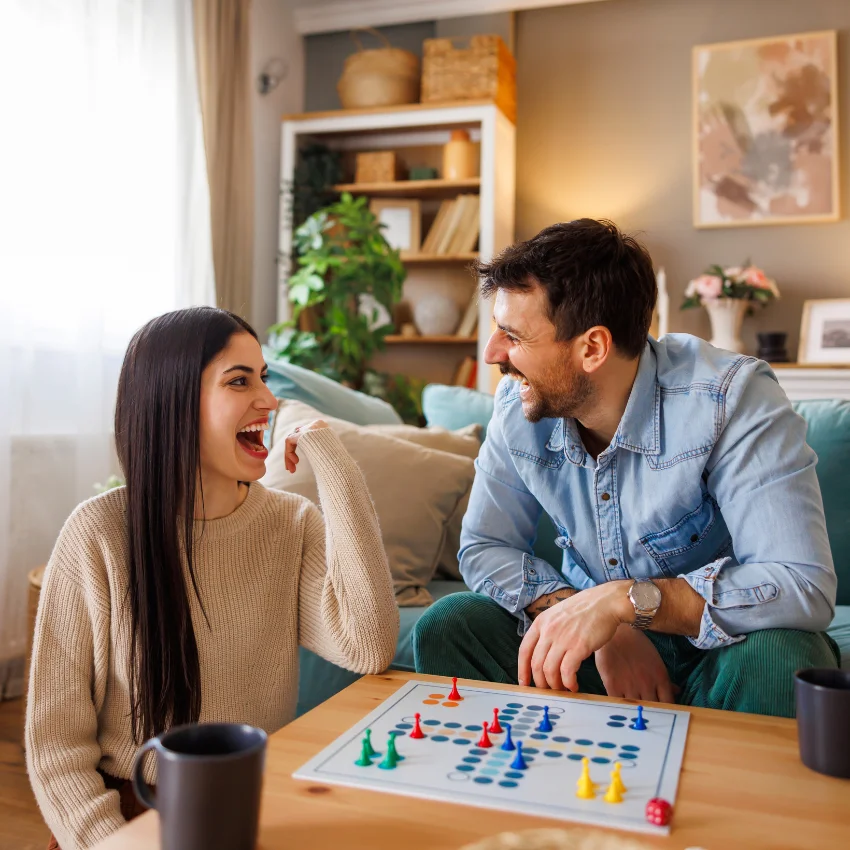 man playing board game with girlfriend prioritizes quality time with his loved ones