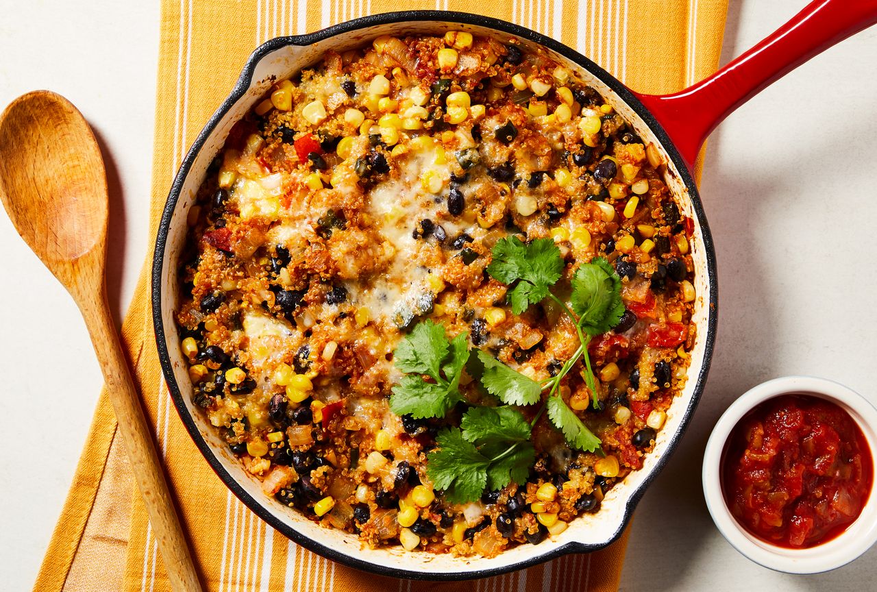 Overhead view of a cast iron skillet of Cheesy Black Bean & Quinoa Skillet Casserole recipe Credit: Photographer: Rachel Marek