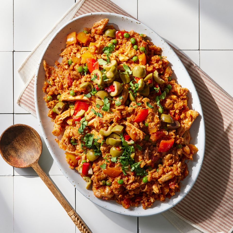 an image of the Slow-Cooker Arroz con Pollo Credit: Photographer: Grant Webster, Food Stylist: Lauren McAnelly, Prop Stylist: Maura Timmerman, Art Director: Maria Emmighausen