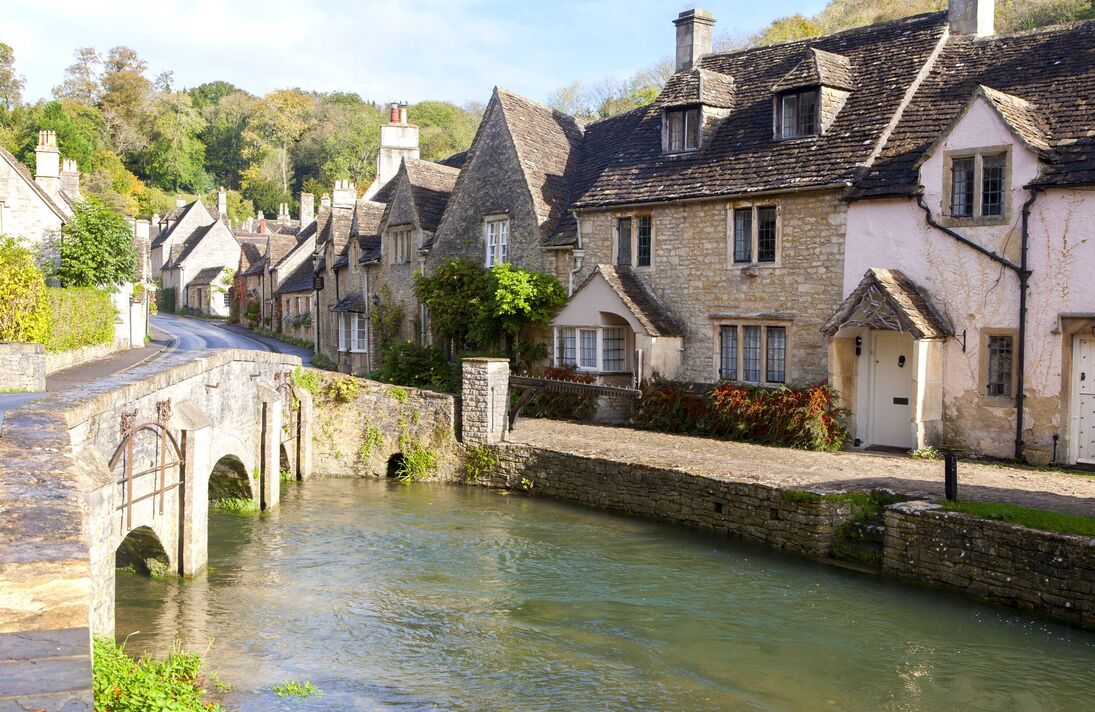 Bybrook River running past stone cottages in Castle Combe, Wiltshire, England