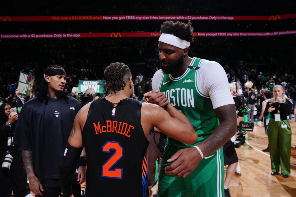 New York Knicks' Miles McBride and Boston Celtics' Mitchell Robinson shake hands after an NBA basketball game.