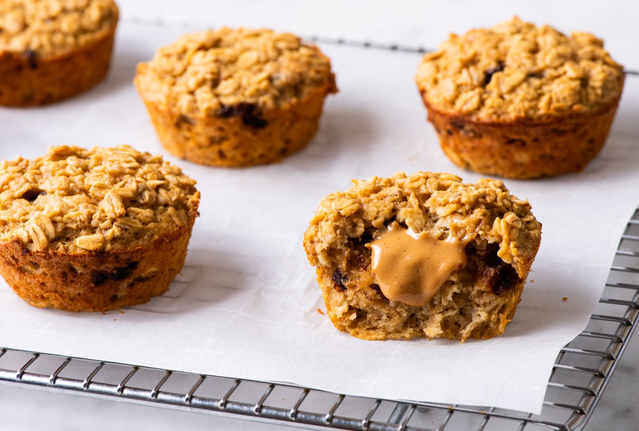 Five breakfast peanut butter-chocolate chip oatmeal cakes, the one in the front halved with a dollop of peanut butter showing filling showing Credit: Alexandra Shytsman